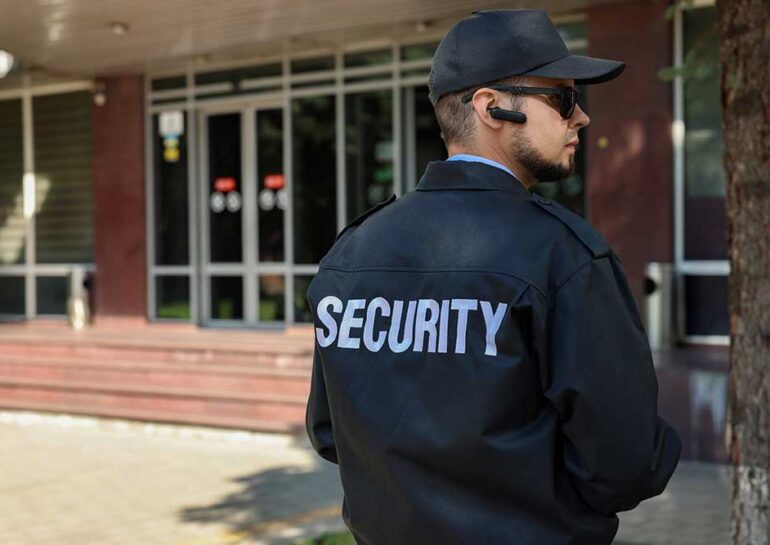 Security guard in uniform and sunglasses outdoors
